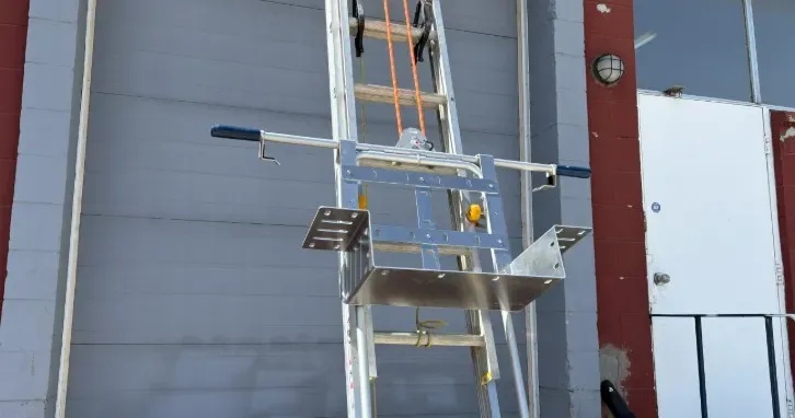 FUEL Solar Lift CarryALL attachment mounted on an extension ladder